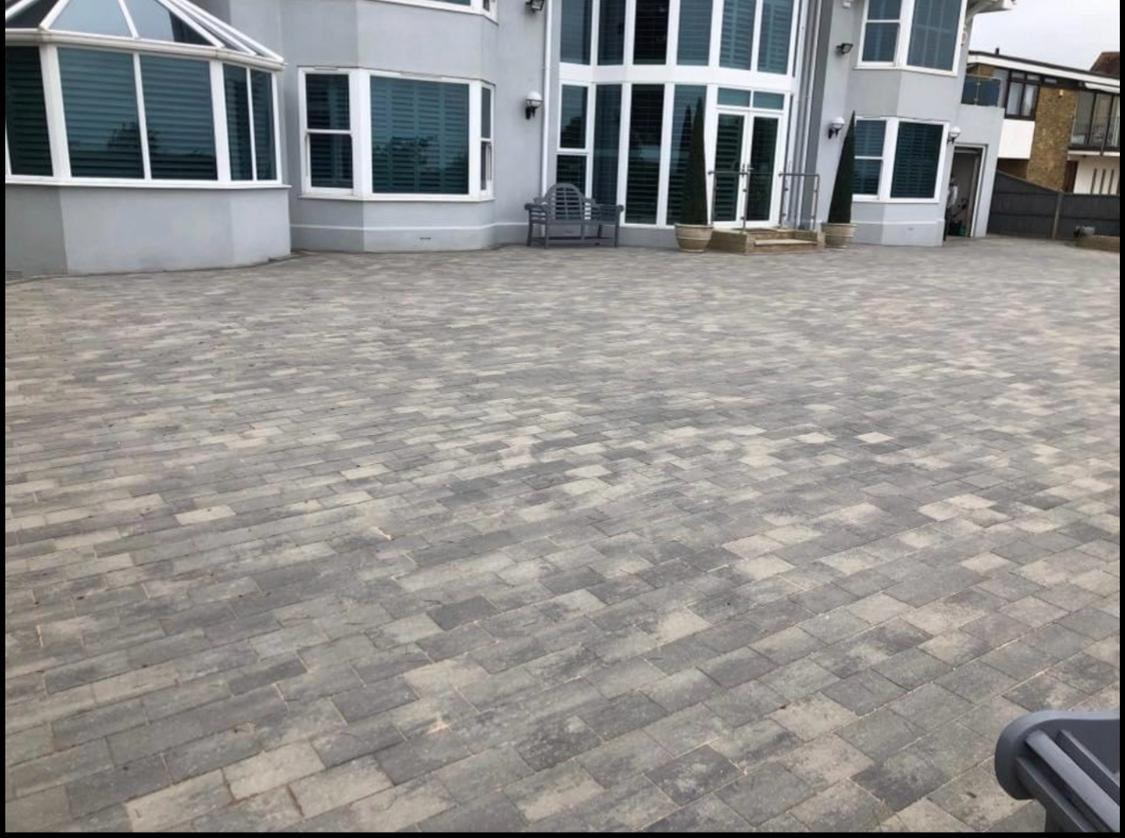 Large block paving courtyard outside a modern home