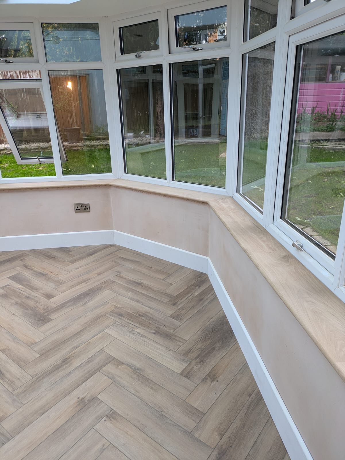 Conservatory interior with herringbone floor and new window boards