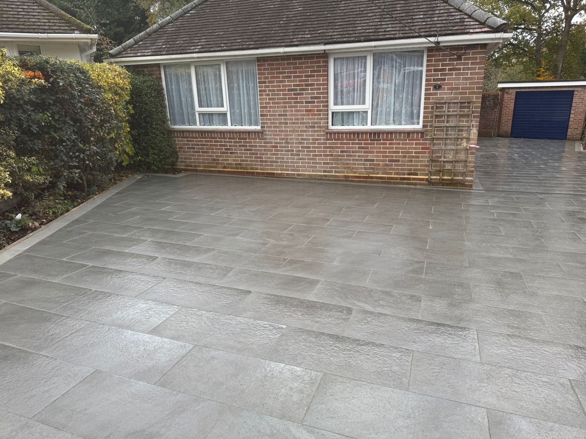 Finished grey porcelain driveway with smooth paving detail