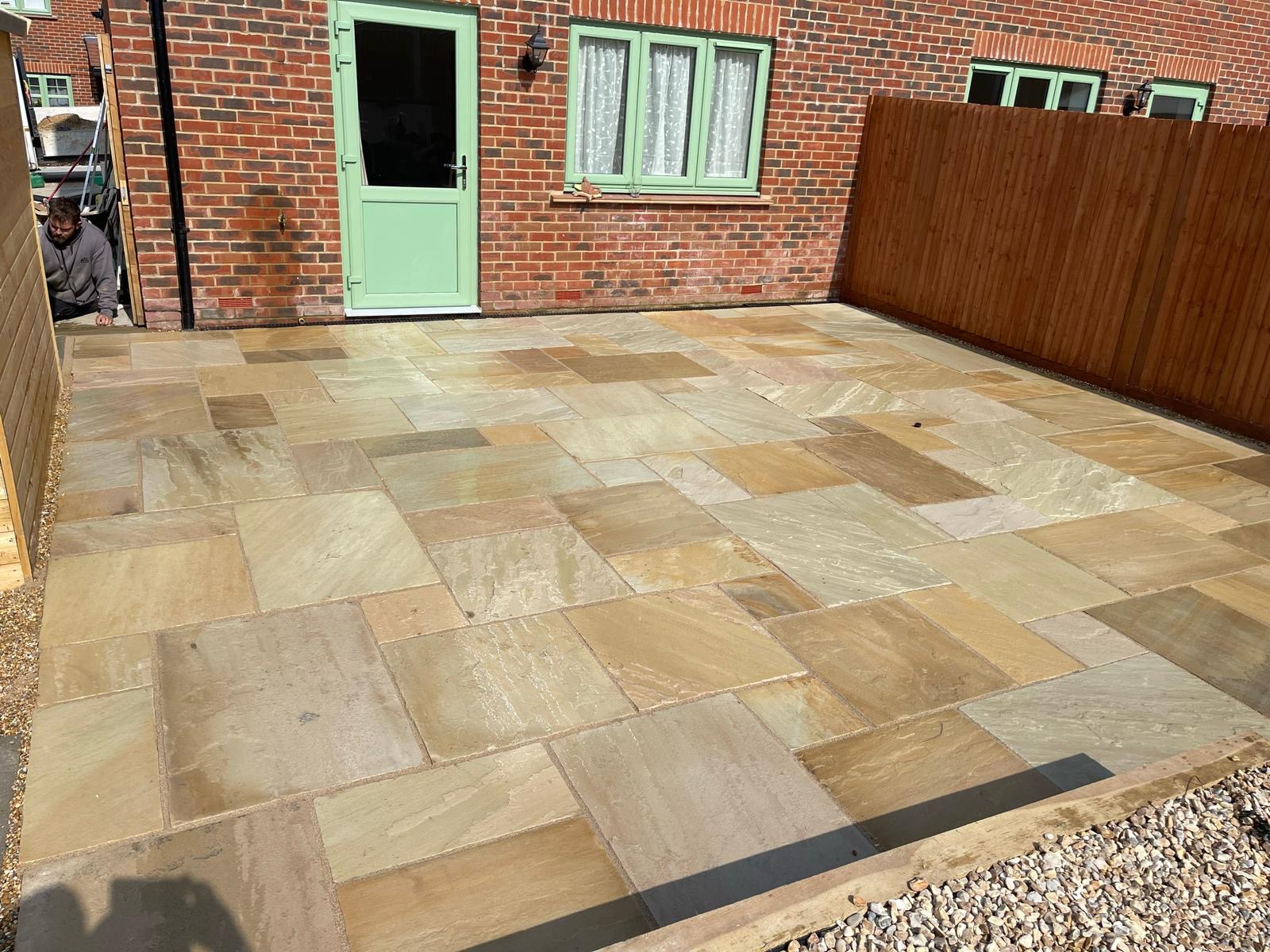 Natural stone courtyard patio outside a brick home