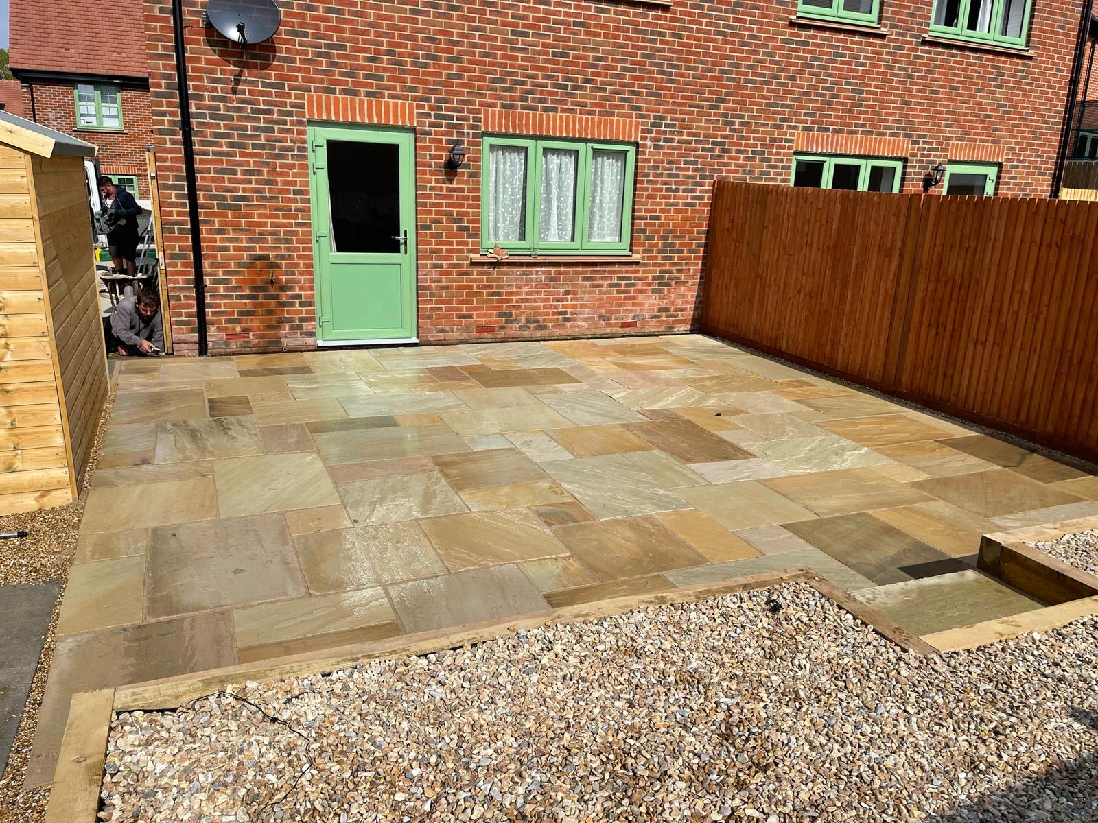 Natural stone courtyard patio with timber fence