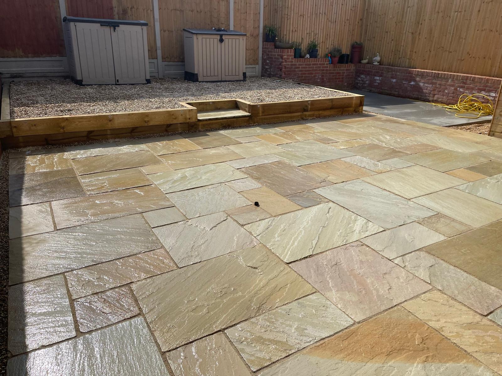 Natural stone patio with gravel section and timber edging