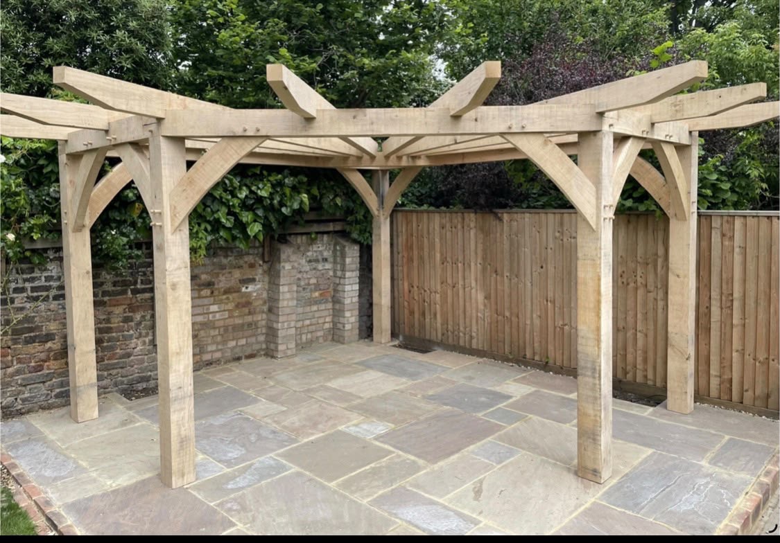 Bespoke oak pergola built over a natural stone patio