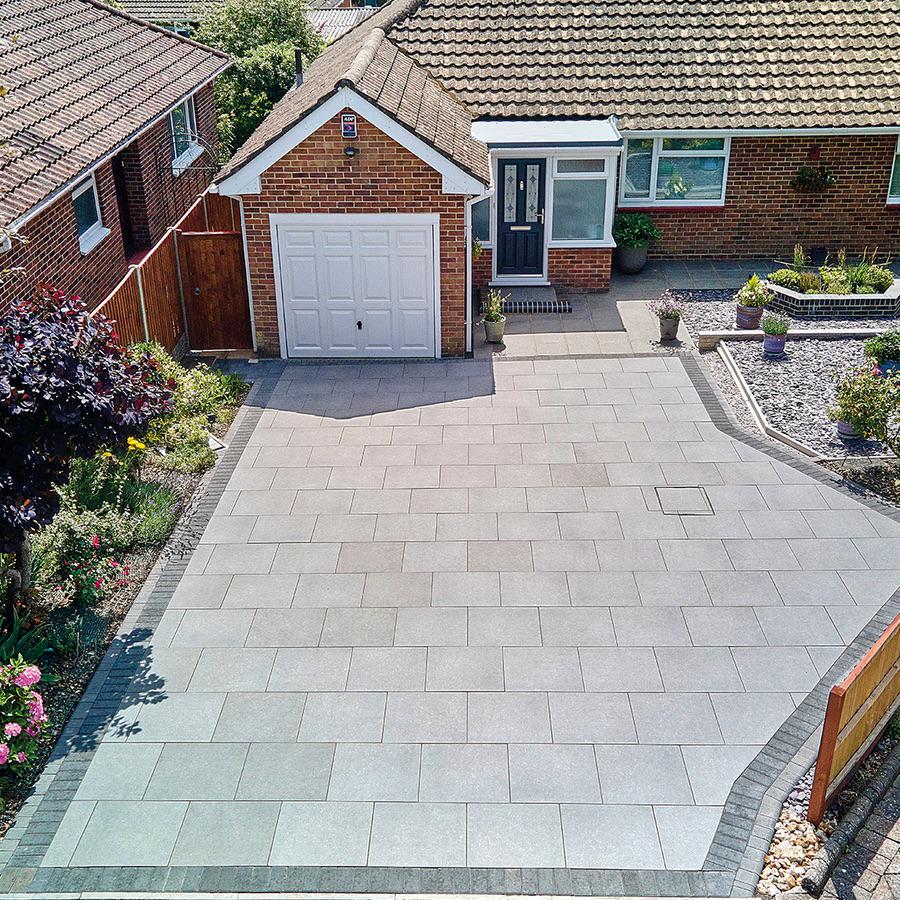 Aerial view of a porcelain driveway with landscaped borders