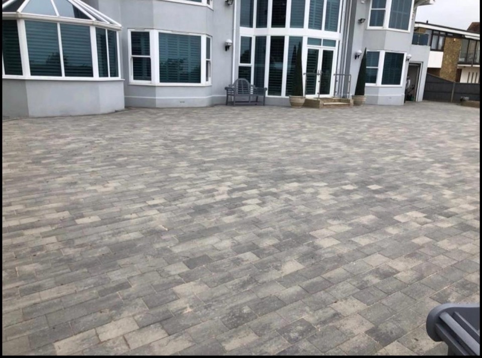Large block paving courtyard outside a modern home