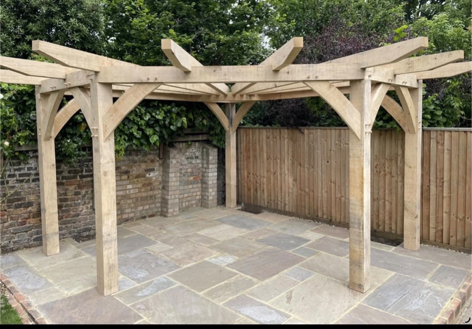 Oak pergola built over a natural stone patio