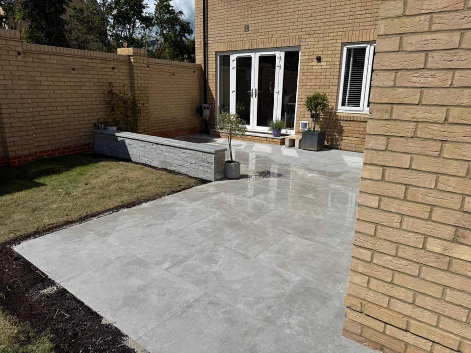 Porcelain patio with raised bed and garden lawn