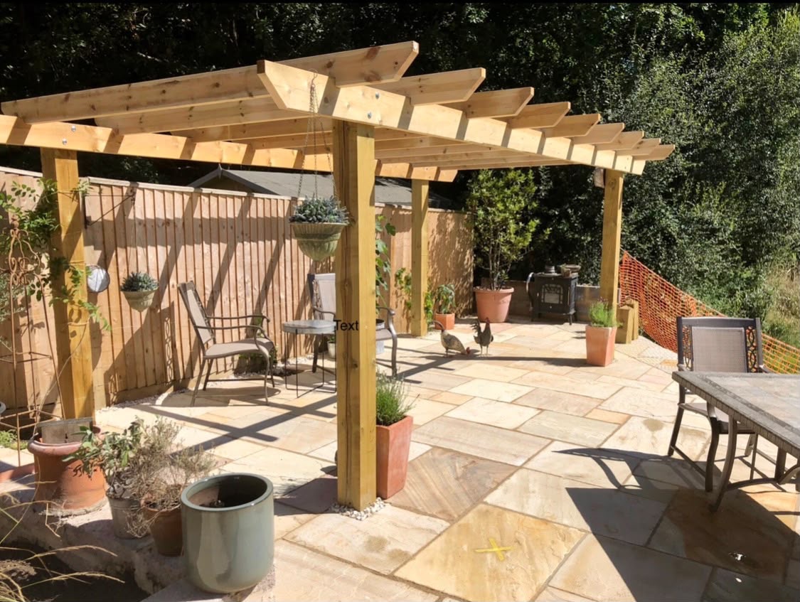 Timber pergola covering a landscaped patio seating area
