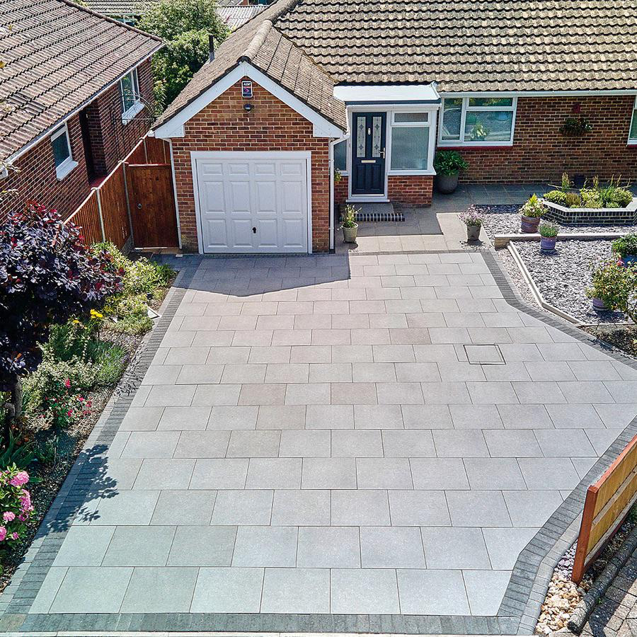 Block paving driveway with landscaped borders outside a bungalow