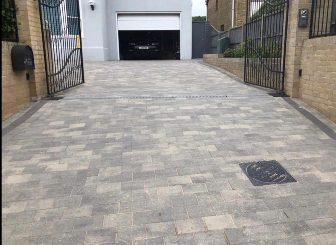 Block paving driveway with entrance gates and garage access