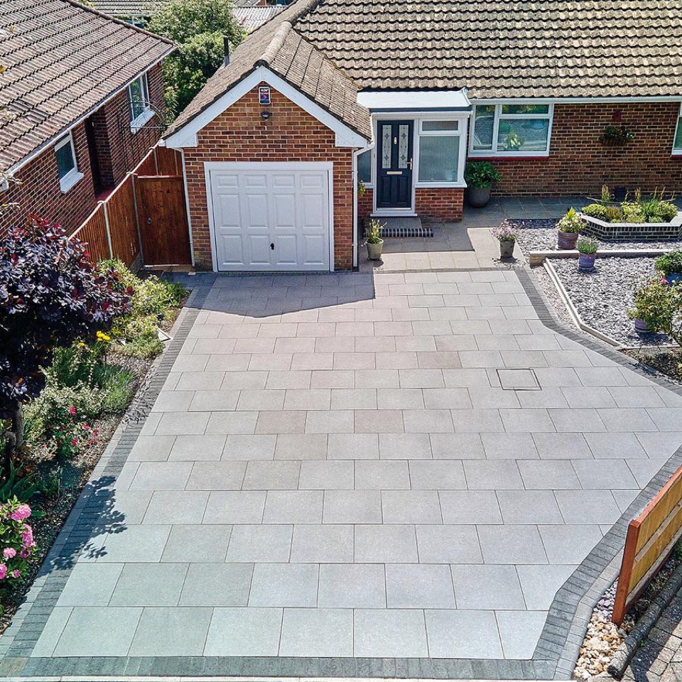 Block paving driveway with landscaped borders outside a bungalow